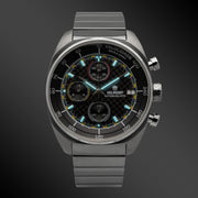 Carbon chronograph glowing on a dark background
