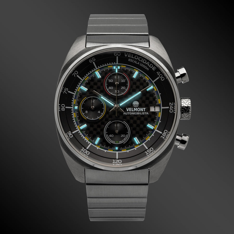 Carbon chronograph glowing on a dark background