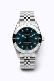 Blue dial watch glowing in low light