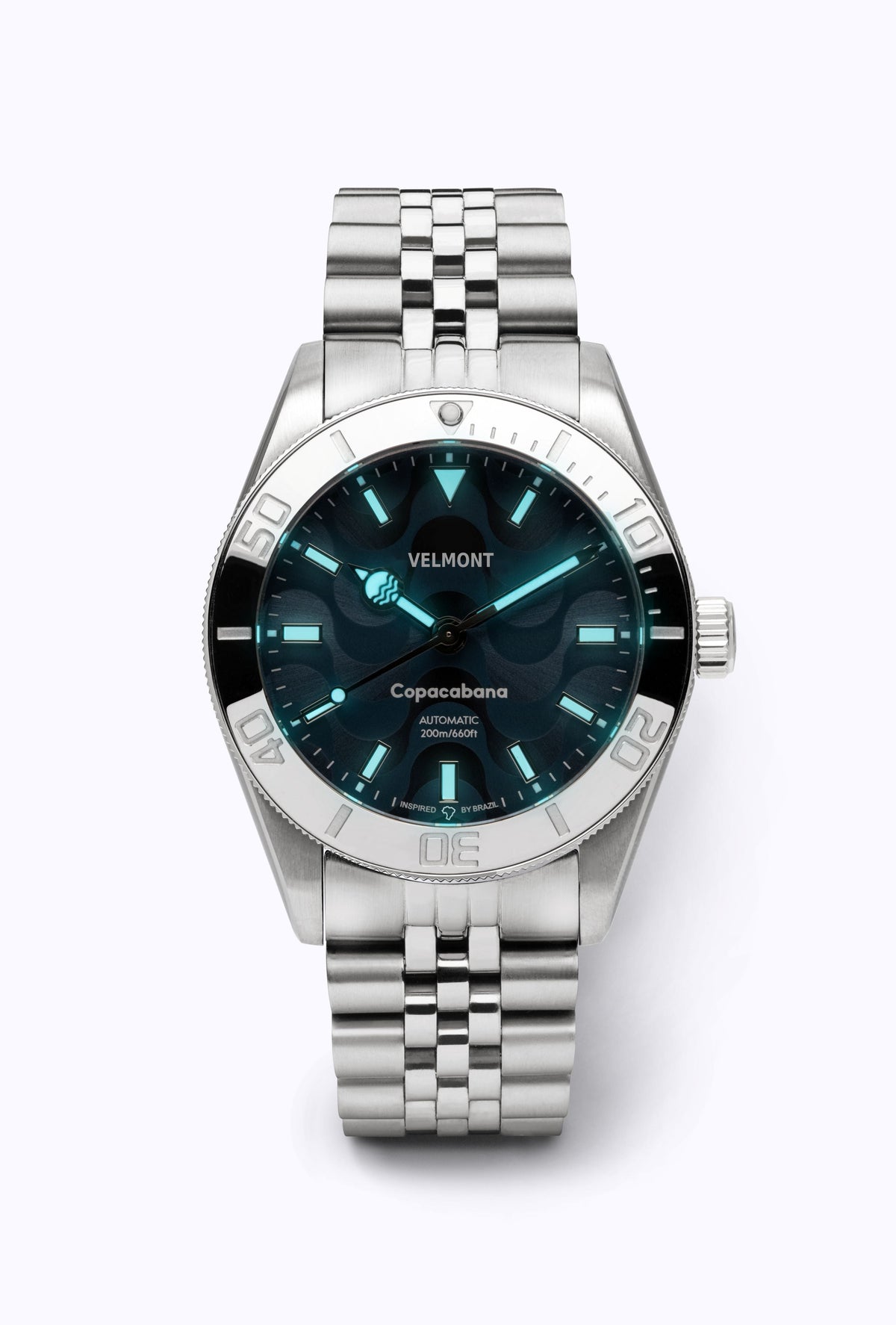 Blue dial watch glowing in low light