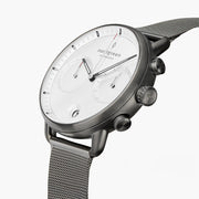 Angled view of the white dial with two subdials and the gunmetal pushers.