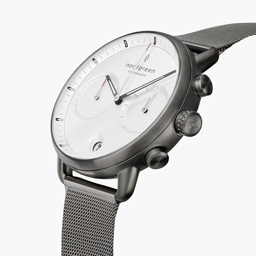 Angled view of the white dial with two subdials and the gunmetal pushers.