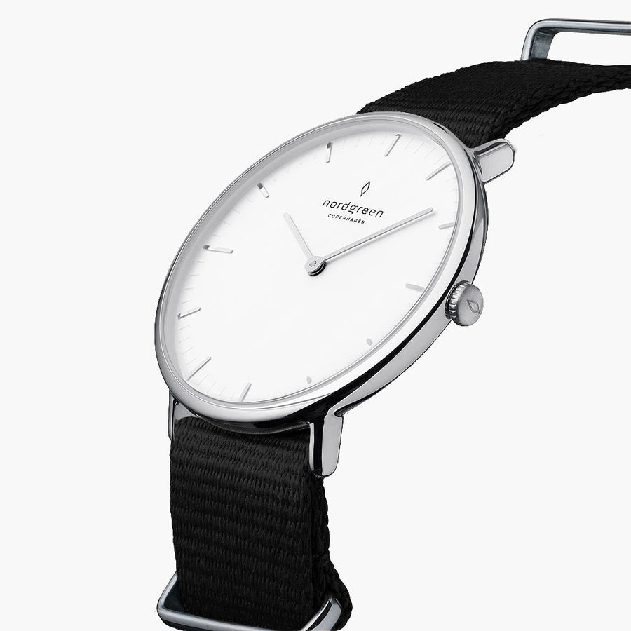 Three-quarter view of the thin silver-tone case on a black fabric strap.