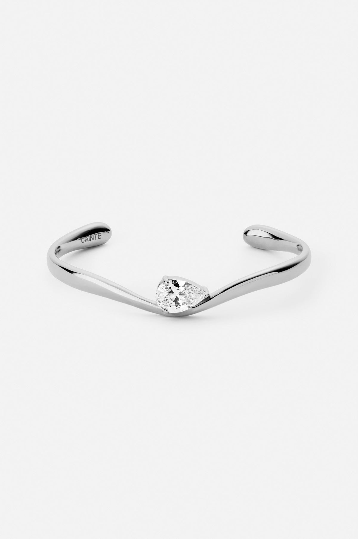 Silver-tone slim wave cuff bracelet, front view on a light background