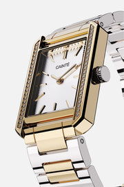 Angled view of the gold-tone case with clear stones along the sides