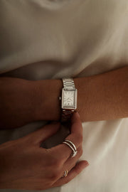 Woman in a white top with the stone-set watch on her wrist