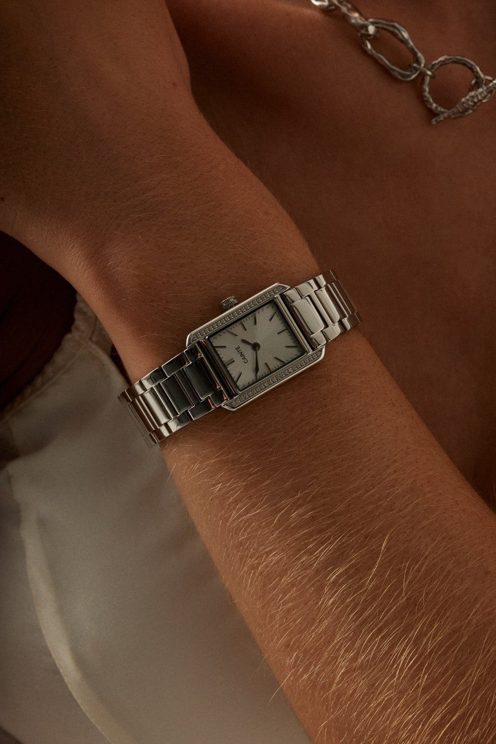 Close-up of the stone-set watch on a woman’s wrist