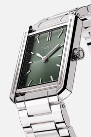 Angled view of the rectangular case and olive green sunburst dial