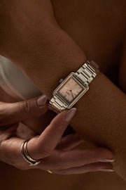 Woman adjusting the rectangular watch on her wrist