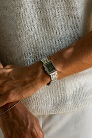 Wrist in a knit sweater wearing the rectangular watch