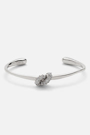 Silver-tone knot cuff bracelet, front view on a light background