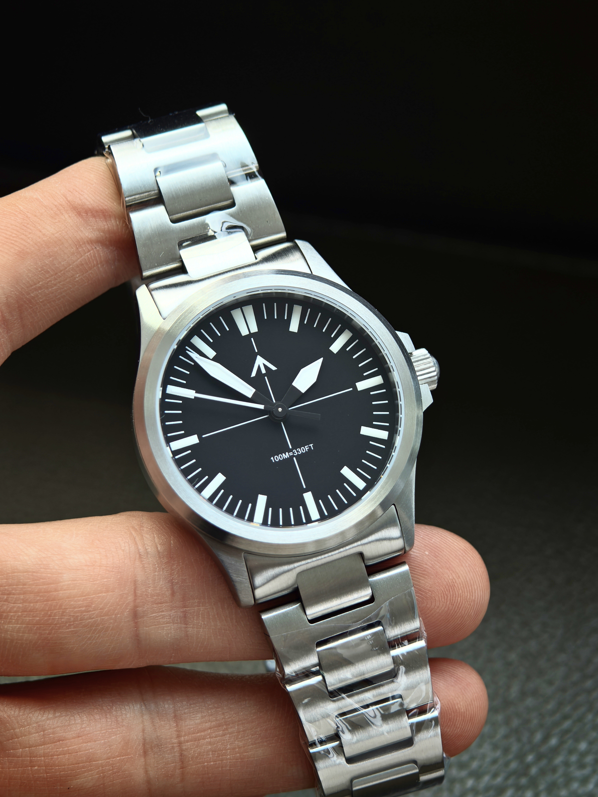 Pilot-style watch held in the hand