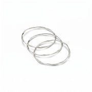 Three twisted silver-tone bangles interlinked