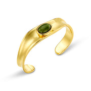 Gold-tone sculpted cuff with an oval green stone