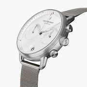 Angled view of the white dial with two subdials and silver-tone pushers.
