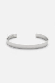Silver-tone polished cuff bracelet, front view on a light background