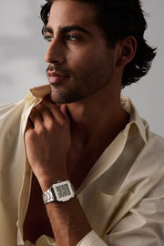 Man resting his chin on his hand, square watch on the wrist