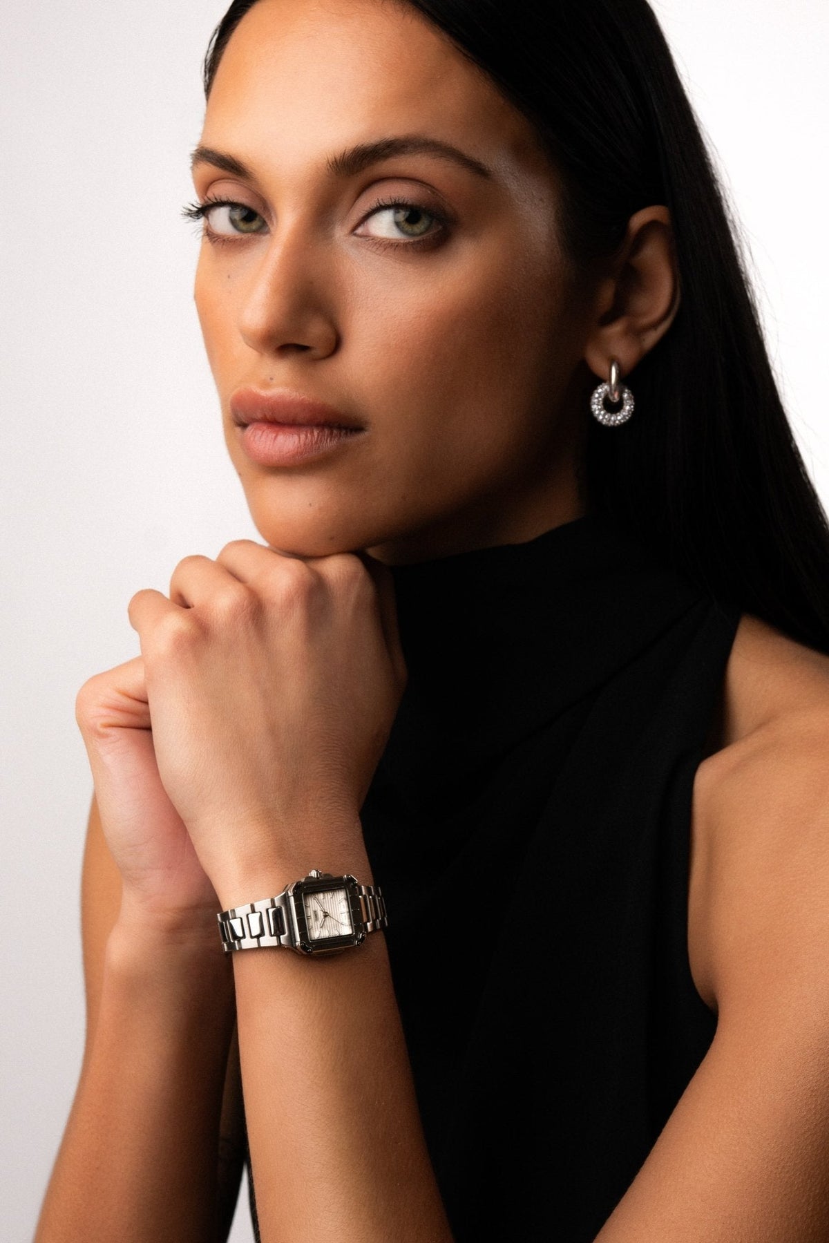 Woman resting her chin on her hands, watch on the wrist