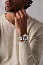 Man resting his chin on his hand, square watch on the wrist