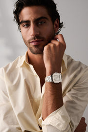 Man resting his chin on his hand, square watch on the wrist