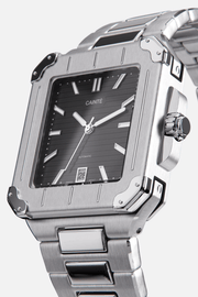 Angled view of the square case with screw details at the corners and black dial