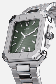 Angled view of the square case with screw details at the corners and green dial