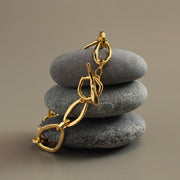Oval link bracelet draped over stacked stones