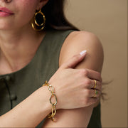 Oval link bracelet worn with matching earrings