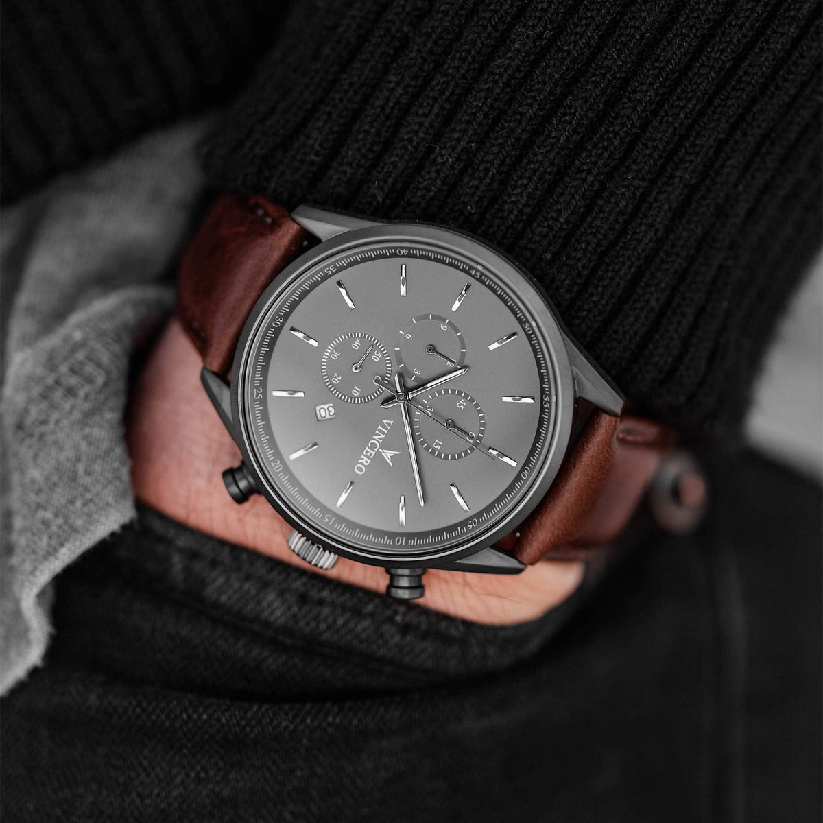 Gunmetal chronograph worn with a black sweater