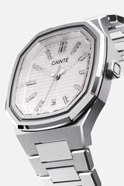 Three-quarter view of the octagonal case and white textured dial
