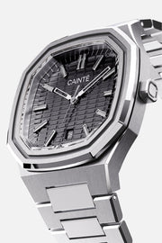 Three-quarter view of the octagonal case and black textured dial