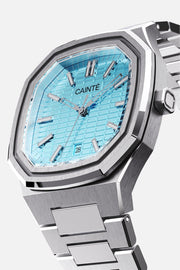 Three-quarter view of the octagonal case and turquoise textured dial