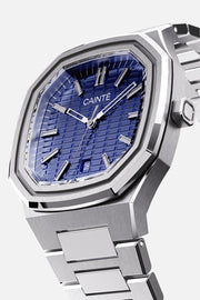 Three-quarter view of the octagonal case and blue textured dial