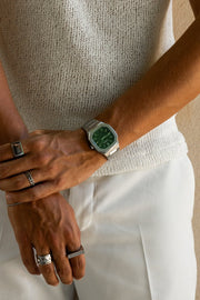 Watch on a wrist against a knit sweater