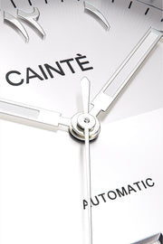 Macro view of the white Arabic numeral dial and polished hands