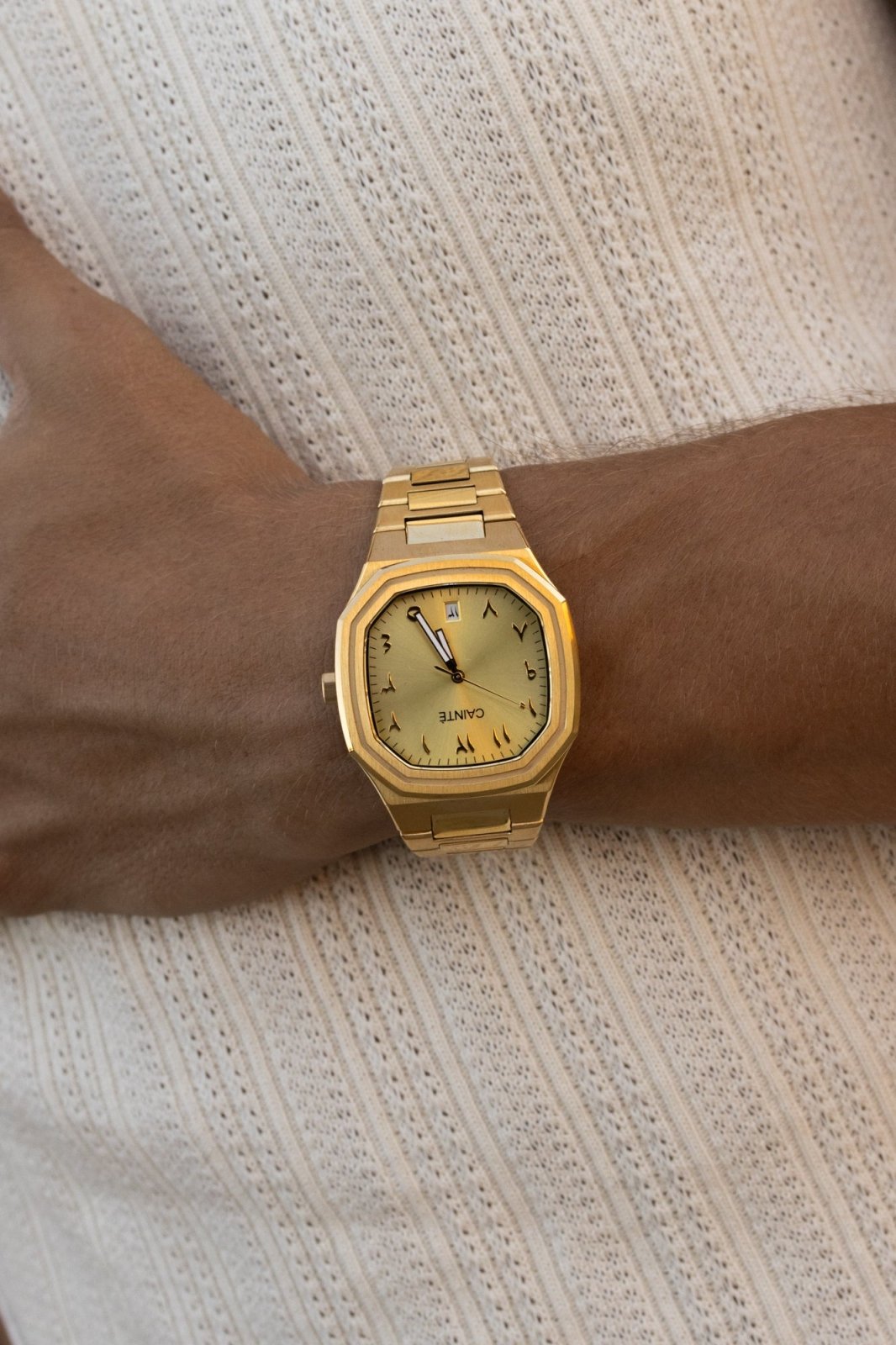 Close-up of the watch on the wrist over a ribbed knit