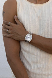 Hand on the upper arm, watch on the wrist