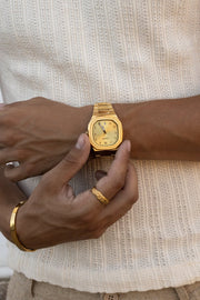 Hand adjusting the watch over a ribbed knit tank