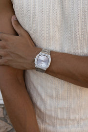 Arm across the body wearing the watch over a knit tank