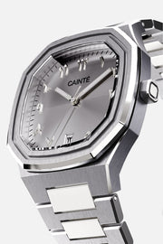 Three-quarter view of the octagonal case and silver Arabic numeral dial
