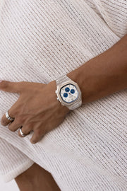 Watch on a wrist against a knit sweater