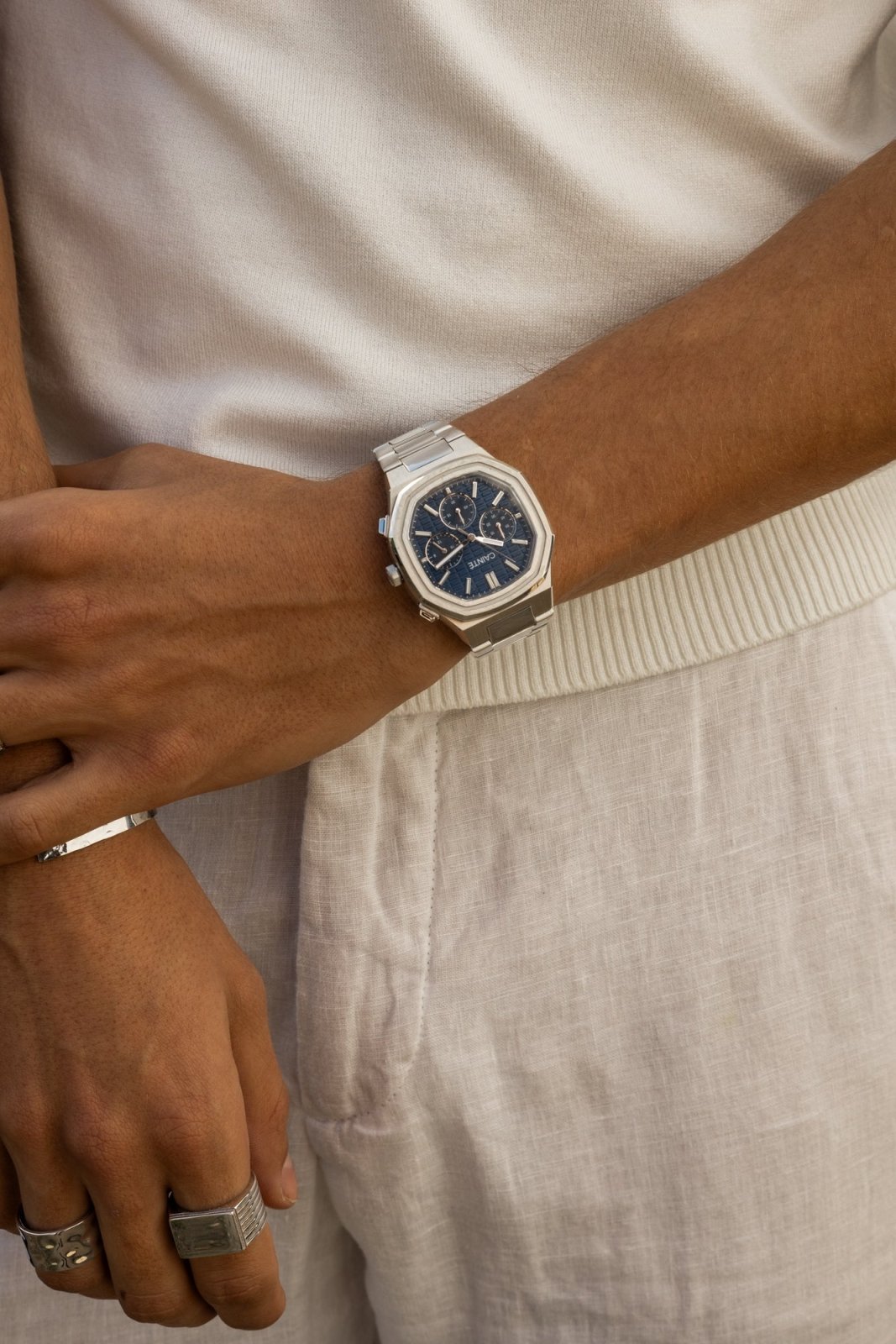 Wrist by linen trousers wearing the watch