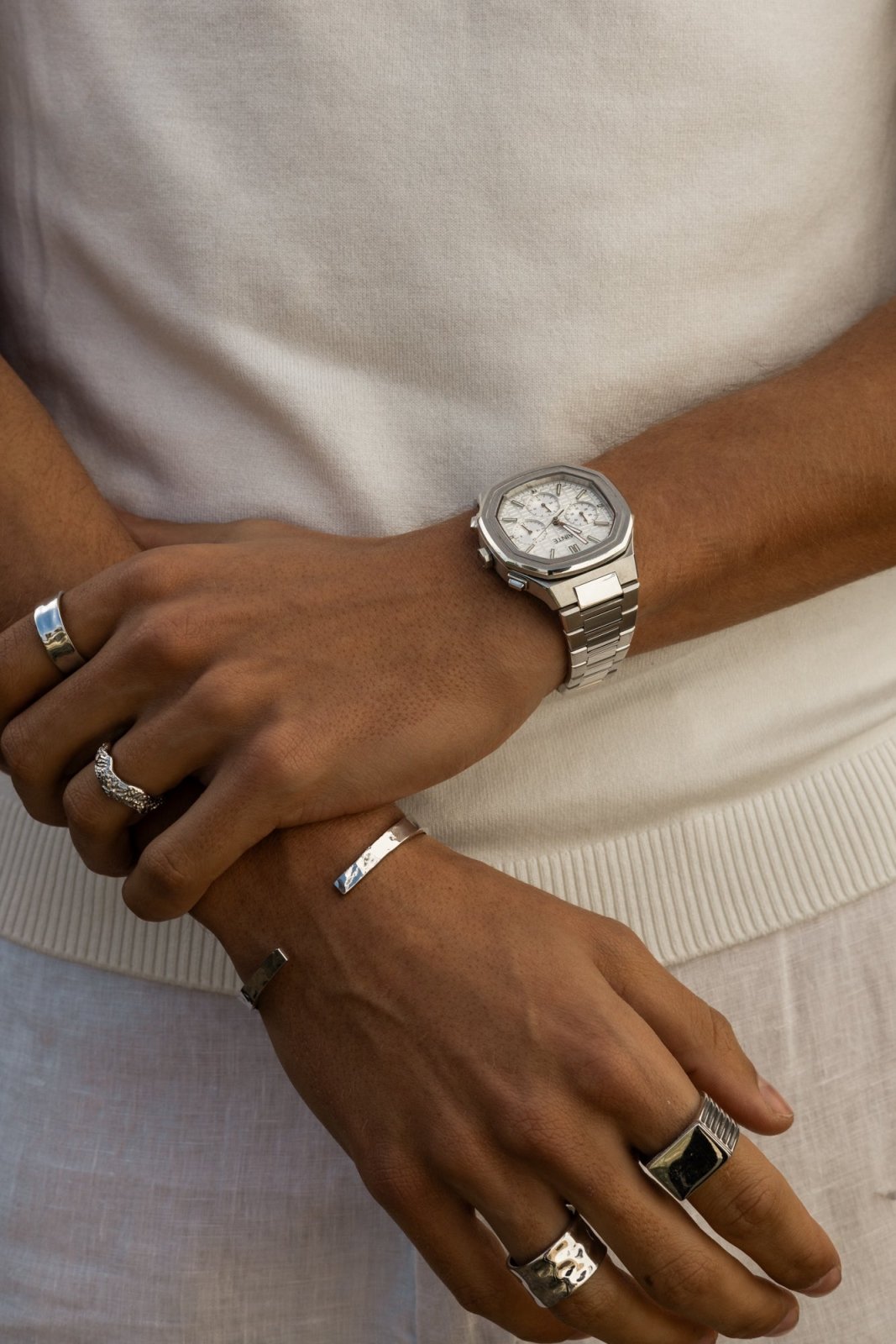 Close view of crossed arms with the watch