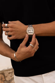 Close view of the watch being adjusted against black