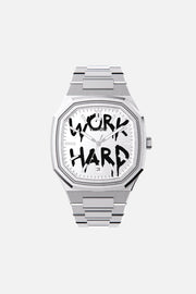 Front view of the octagonal watch with white dial with black graffiti lettering on its integrated bracelet