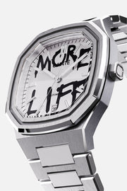 Three-quarter view of the octagonal case and white dial with black graffiti lettering