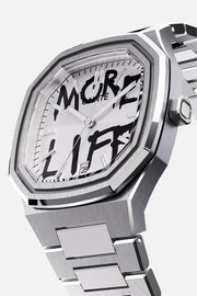 Three-quarter view of the octagonal case and white dial with black graffiti lettering