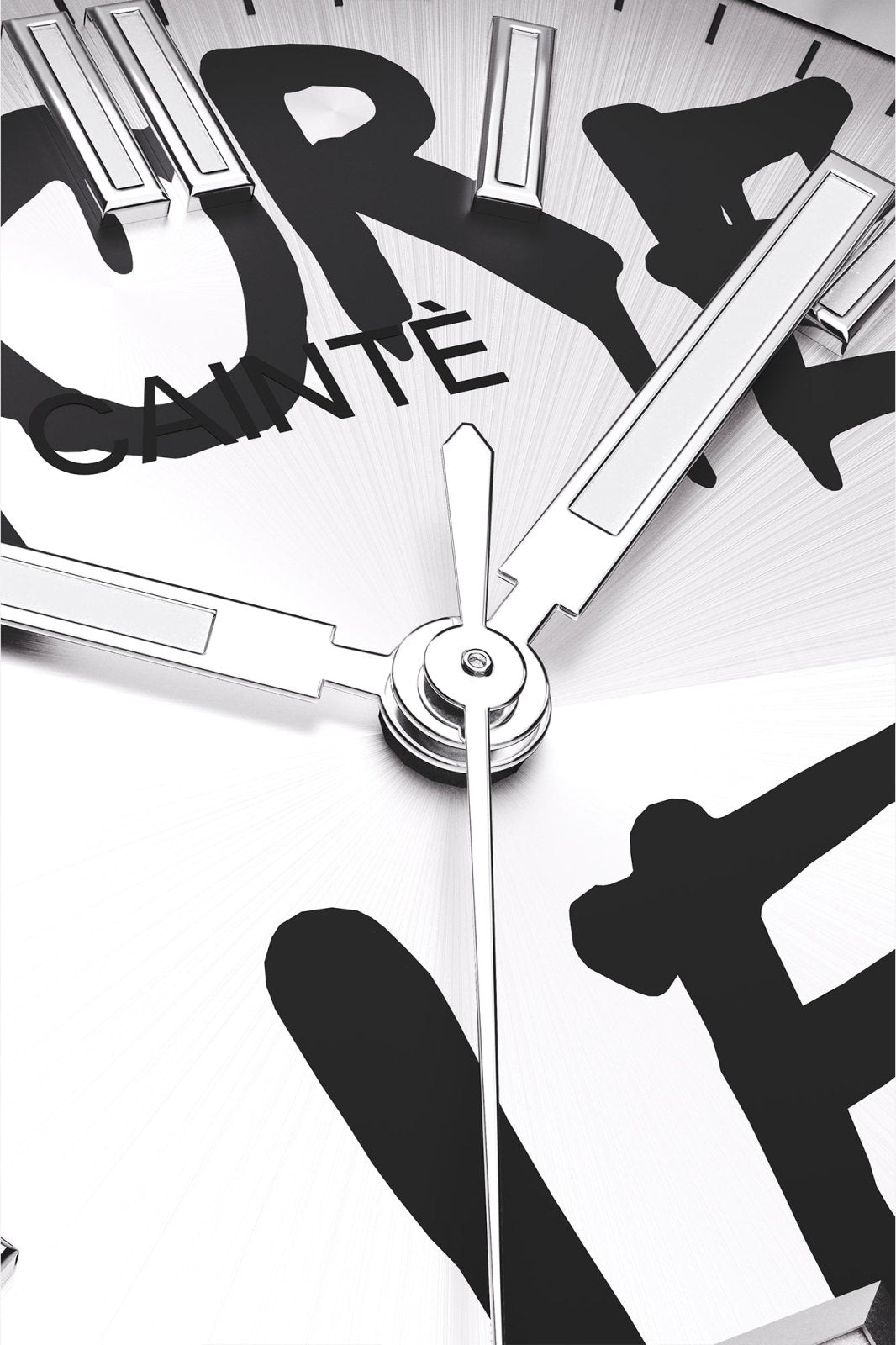 Macro view of the white dial with black graffiti lettering and polished hands