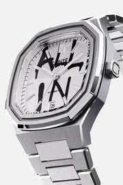 Three-quarter view of the octagonal case and white dial with black graffiti lettering