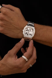 Close view of the watch being adjusted against black